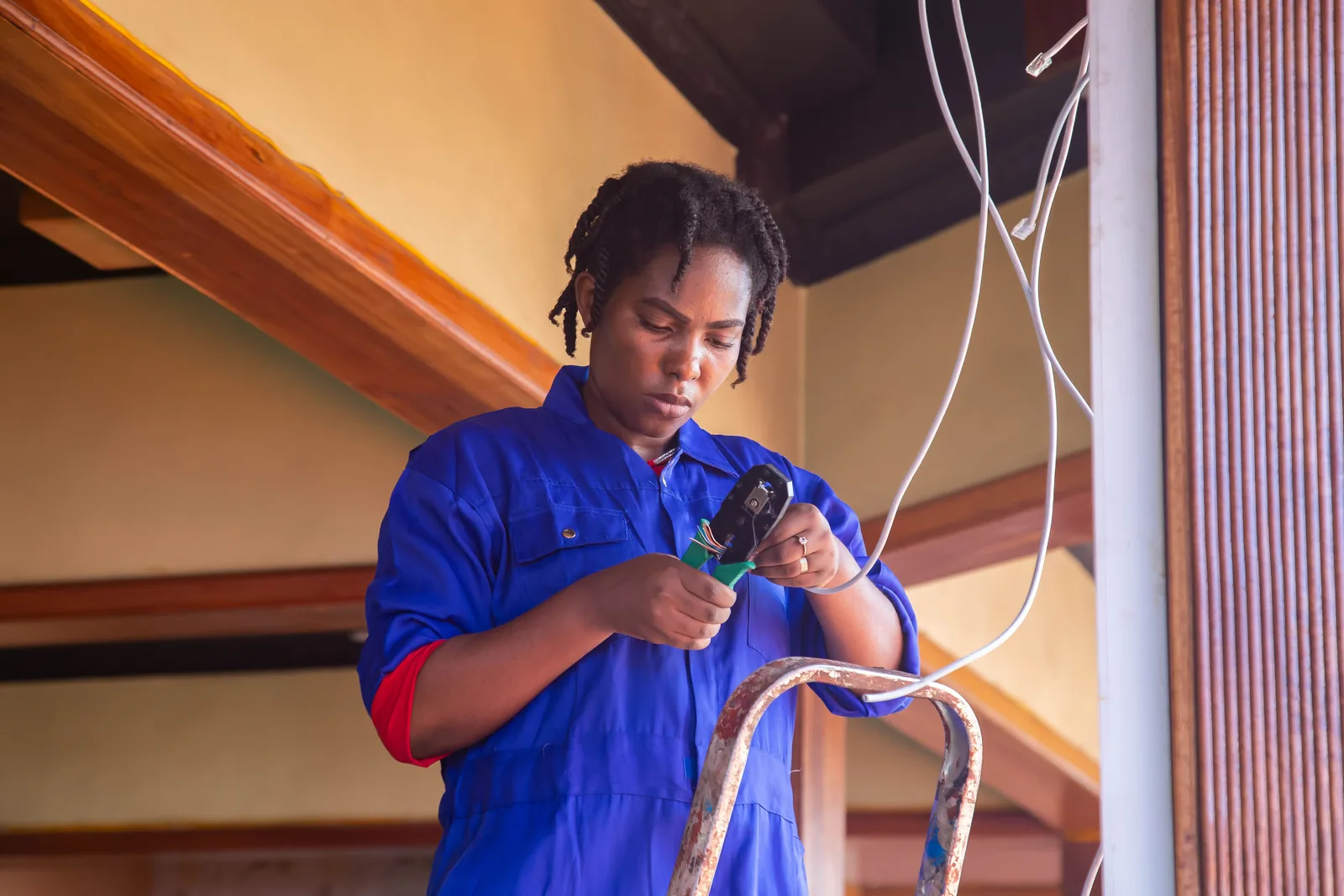 Terminating a cable from a step ladder, for electrician services in Calgary