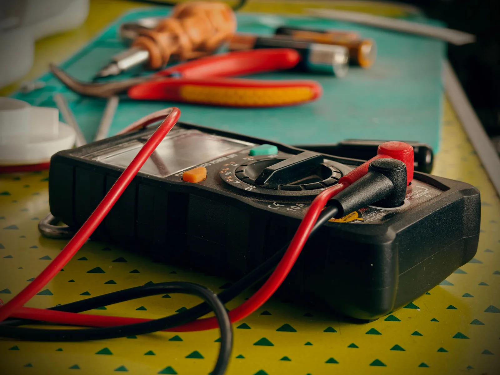 A multimeter and hand tools ready for a diagnostic visit, for electrician in Calgary